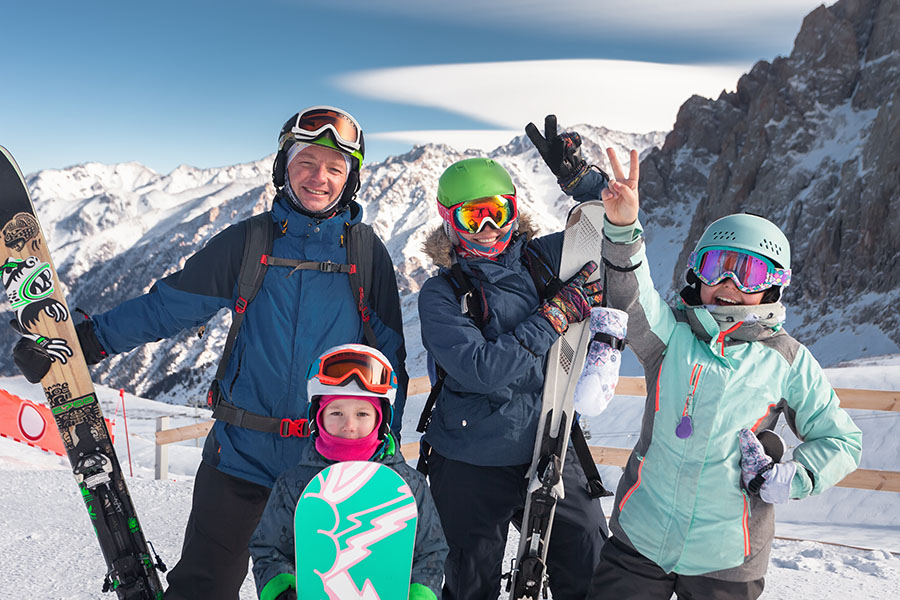 Happy family on luxury ski trip